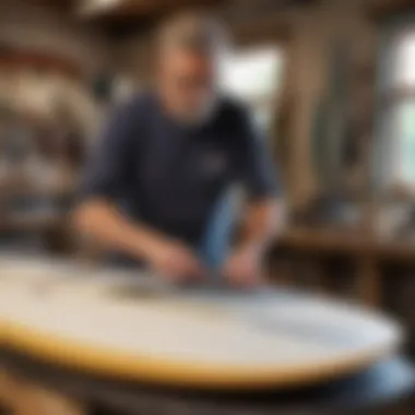 An artisan at work shaping a surfboard with precision tools in a sunlit workshop