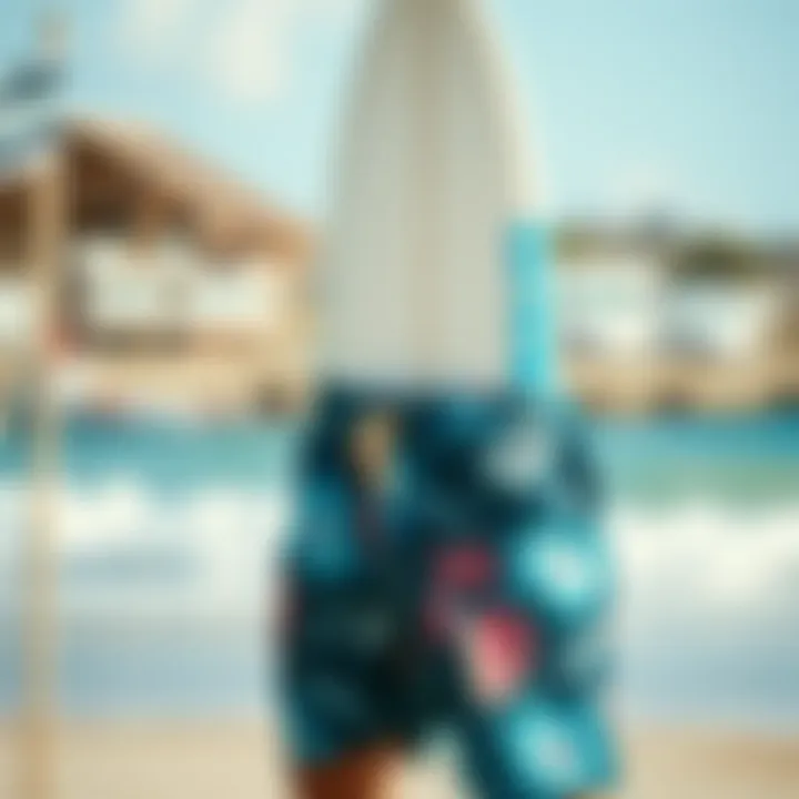 A surfboard and board shorts against a beach backdrop