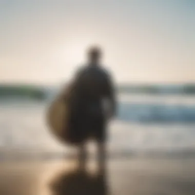 A surfer wearing a dry robe on the beach