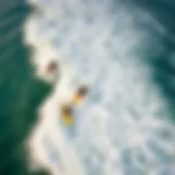 Aerial view of surfers riding waves