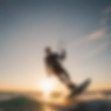 A kitesurfer catching air with a beautiful sunset backdrop