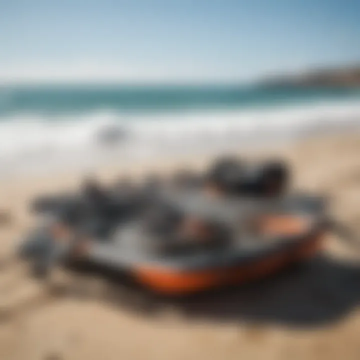 Kitesurfing gear laid out on the beach with ocean backdrop