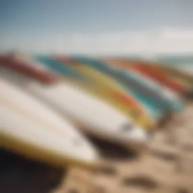 A close-up of surfboards lined up on the beach, ready for action