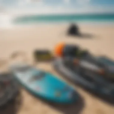 An array of kiteboarding gear laid out on the sandy beach under a bright sun