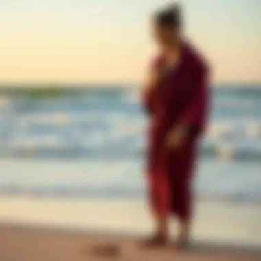 Surfer in a Robe on the Beach A serene beach scene with a surfer putting on a robe after a session