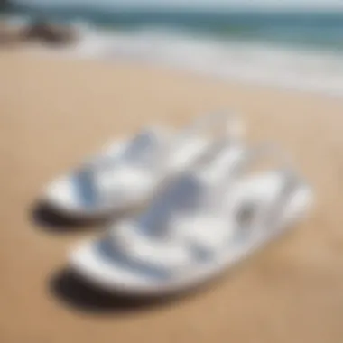 Pair of white Sanuks on a sandy beach