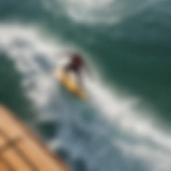 An aerial view of a surfer executing an ollie in the ocean