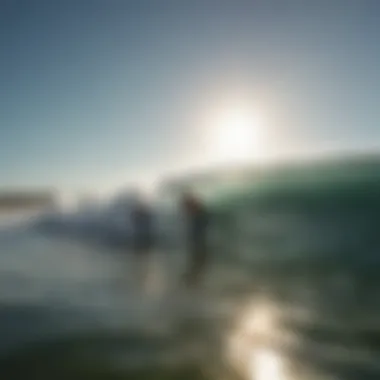 A serene coastline with surfers catching waves under a bright sun.