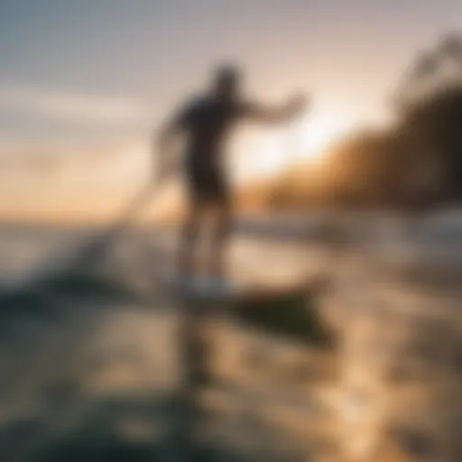 A paddleboarder riding a wave at sunset