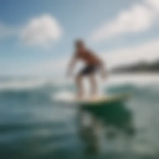 A novice surfer practicing balance on a surfboard in calm waters