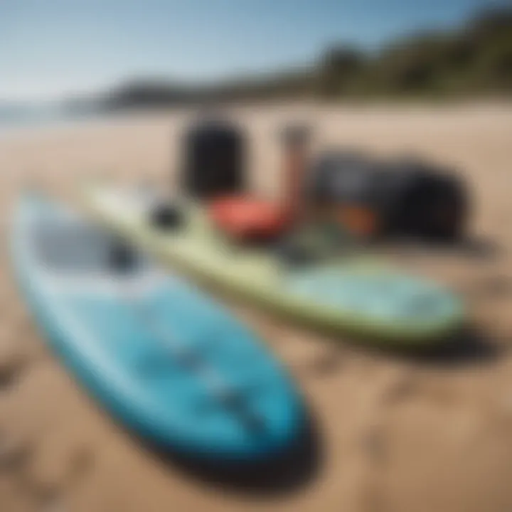 A well-organized collection of paddleboarding gear laid out on the sand