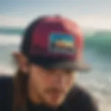 A close-up of a vibrant snapback hat with surfing-themed graphics